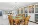 Open-concept dining area flowing into living room, featuring abundant cabinet space, modern lighting, and natural light at 3966 Crystal Trip Ct, Las Vegas, NV 89129
