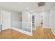 Bright hallway with hardwood floors, white trim, and multiple entryways to other rooms at 3966 Crystal Trip Ct, Las Vegas, NV 89129
