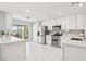 The kitchen has stainless steel appliances, white cabinets, and sliding glass doors to the backyard at 3966 Crystal Trip Ct, Las Vegas, NV 89129