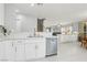 Bright kitchen with white cabinets, stainless steel dishwasher, and open view to the living room at 3966 Crystal Trip Ct, Las Vegas, NV 89129