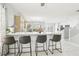 Open floor plan with breakfast bar, white cabinets, tile floors, and view of the dining area at 3966 Crystal Trip Ct, Las Vegas, NV 89129