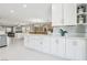 Bright kitchen with white cabinets, bar seating, and open view to the dining and living area at 3966 Crystal Trip Ct, Las Vegas, NV 89129