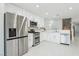 Kitchen featuring stainless steel appliances, white cabinets, tile flooring, and bright lighting at 3966 Crystal Trip Ct, Las Vegas, NV 89129