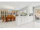 Bright kitchen featuring white cabinets, white tile floors, and dining area with display cabinet at 3966 Crystal Trip Ct, Las Vegas, NV 89129