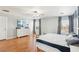 Spacious main bedroom with hardwood floors, large TV, dresser, and lots of natural light at 3966 Crystal Trip Ct, Las Vegas, NV 89129