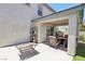Covered patio with modern furniture, artificial turf, and an outdoor shelving unit at 3966 Crystal Trip Ct, Las Vegas, NV 89129
