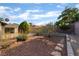 A beautiful backyard featuring desert landscaping, shrubs, and a stone pathway at 4016 Stormcrest Dr, Las Vegas, NV 89107