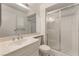 Bathroom featuring a shower, sink, toilet, and a mirrored wall cabinet at 4016 Stormcrest Dr, Las Vegas, NV 89107