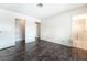 Neutral bedroom with dark wood floors and ensuite bathroom with shower at 4016 Stormcrest Dr, Las Vegas, NV 89107