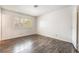 Bedroom features dark wood floors, shuttered windows, and ample natural light at 4016 Stormcrest Dr, Las Vegas, NV 89107