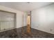 Bedroom featuring laminate floors, neutral walls, closet and a door to the hallway at 4016 Stormcrest Dr, Las Vegas, NV 89107