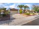 A well-maintained single-story home with palm trees, a two-car garage and inviting curb appeal at 4016 Stormcrest Dr, Las Vegas, NV 89107