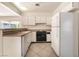 Bright kitchen with a white refrigerator and cabinets, and an opening to the living area at 4016 Stormcrest Dr, Las Vegas, NV 89107