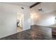 Open living room showcasing wood floors, access to the kitchen, vaulted ceilings and bright light at 4016 Stormcrest Dr, Las Vegas, NV 89107