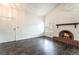 Cozy living room with dark wood floors, brick fireplace, vaulted ceiling and bright light at 4016 Stormcrest Dr, Las Vegas, NV 89107
