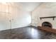 Inviting living room with dark wood floors, brick fireplace, vaulted ceiling and bright light at 4016 Stormcrest Dr, Las Vegas, NV 89107
