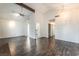 Large living room showing wood floors, vaulted ceilings, access to the kitchen, and natural lighting at 4016 Stormcrest Dr, Las Vegas, NV 89107