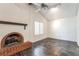Bright living room featuring a brick fireplace, dark wood floors, and vaulted ceilings at 4016 Stormcrest Dr, Las Vegas, NV 89107