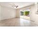 Spacious living area with a sliding glass door to the backyard and neutral tile flooring at 4016 Stormcrest Dr, Las Vegas, NV 89107