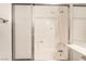 Bathroom featuring shower-tub combination with white sliding doors and silver hardware at 4016 Stormcrest Dr, Las Vegas, NV 89107