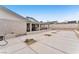 Backyard with large concrete area and open air patio with blue trim at 4386 El Cebra Way, Las Vegas, NV 89121