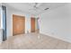 Bedroom with ceiling fan, closet doors, tile flooring and a doorway at 4386 El Cebra Way, Las Vegas, NV 89121