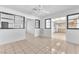 Open concept living room featuring tile flooring, ceiling fan, and open access to kitchen at 4386 El Cebra Way, Las Vegas, NV 89121