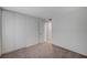Empty bedroom with neutral carpet, sliding closet doors and a view to the hall at 4496 Skyview Dr, Las Vegas, NV 89104