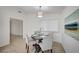 Cozy dining area with a round table, seating for four, and a modern chandelier at 4496 Skyview Dr, Las Vegas, NV 89104