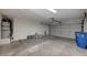 Spacious garage with a roll up door providing ample room for parking and storage at 4496 Skyview Dr, Las Vegas, NV 89104