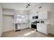 Updated kitchen with white cabinets, stainless steel appliances, and modern countertops at 4496 Skyview Dr, Las Vegas, NV 89104