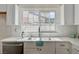 Bright kitchen featuring a stainless steel sink and modern white cabinets at 4496 Skyview Dr, Las Vegas, NV 89104