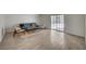 Bright living room with wood-look tile flooring, ample natural light, and modern decor at 4496 Skyview Dr, Las Vegas, NV 89104