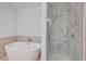 Luxurious bathroom featuring a soaking tub and glass enclosed shower with marble tile at 4525 Dean Martin Dr # 909, Las Vegas, NV 89103