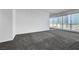 Large bedroom featuring neutral carpet and expansive windows with city views at 4525 Dean Martin Dr # 909, Las Vegas, NV 89103