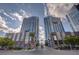 Condo building features modern architecture, complemented by palm trees and lush landscaping at 4525 Dean Martin Dr # 909, Las Vegas, NV 89103