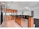 Modern kitchen with stainless steel appliances, wooden cabinetry, and granite countertops at 4525 Dean Martin Dr # 909, Las Vegas, NV 89103