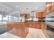 An open kitchen featuring a large island, granite countertops, and stainless steel appliances at 4525 Dean Martin Dr # 909, Las Vegas, NV 89103