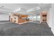Open-concept living room showcasing floor-to-ceiling windows, neutral carpet, and a modern kitchen at 4525 Dean Martin Dr # 909, Las Vegas, NV 89103
