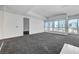 Bright living room with floor-to-ceiling windows offering stunning city views and neutral carpeting throughout at 4525 Dean Martin Dr # 909, Las Vegas, NV 89103