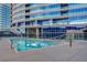 Luxury pool and tanning deck with inviting cool, blue water, lounge seating and city views at 4525 Dean Martin Dr # 909, Las Vegas, NV 89103