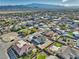 An aerial view of a residential community showcases the home and surrounding well-kept neighborhood homes, landscaping, and street layout at 4861 Ridgewood, Pahrump, NV 89061