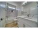 Bright bathroom featuring modern fixtures, granite-look vanity, and tiled tub with shower at 4861 Ridgewood, Pahrump, NV 89061