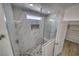 Modern bathroom featuring a spacious shower with marble-look tile and pebble flooring at 4861 Ridgewood, Pahrump, NV 89061
