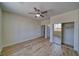 Bright bedroom with wood-look flooring, ceiling fan, and closet with sliding doors at 4861 Ridgewood, Pahrump, NV 89061