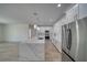 Modern kitchen features an island, stainless steel appliances, and sleek white cabinetry at 4861 Ridgewood, Pahrump, NV 89061