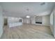 Open floor plan with light wood floors connecting the kitchen to a living area with fireplace at 4861 Ridgewood, Pahrump, NV 89061
