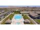 Aerial view of a community pool area with clear blue water, surrounded by trees and covered cabanas at 489 Open Hill Ave, Henderson, NV 89011
