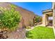 Charming backyard featuring a green lawn, desert landscaping, and a brick wall for added privacy at 489 Open Hill Ave, Henderson, NV 89011