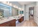 Well-lit bathroom featuring double sinks, a vanity area, and a glass-enclosed shower at 489 Open Hill Ave, Henderson, NV 89011